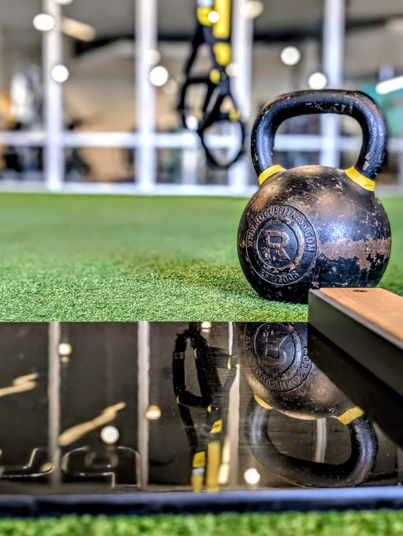Kettlebell and slide board on the turf for VIVE Arena SLIDE